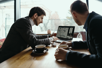 two-young-businessman-having-successful-meeting-restaurant
